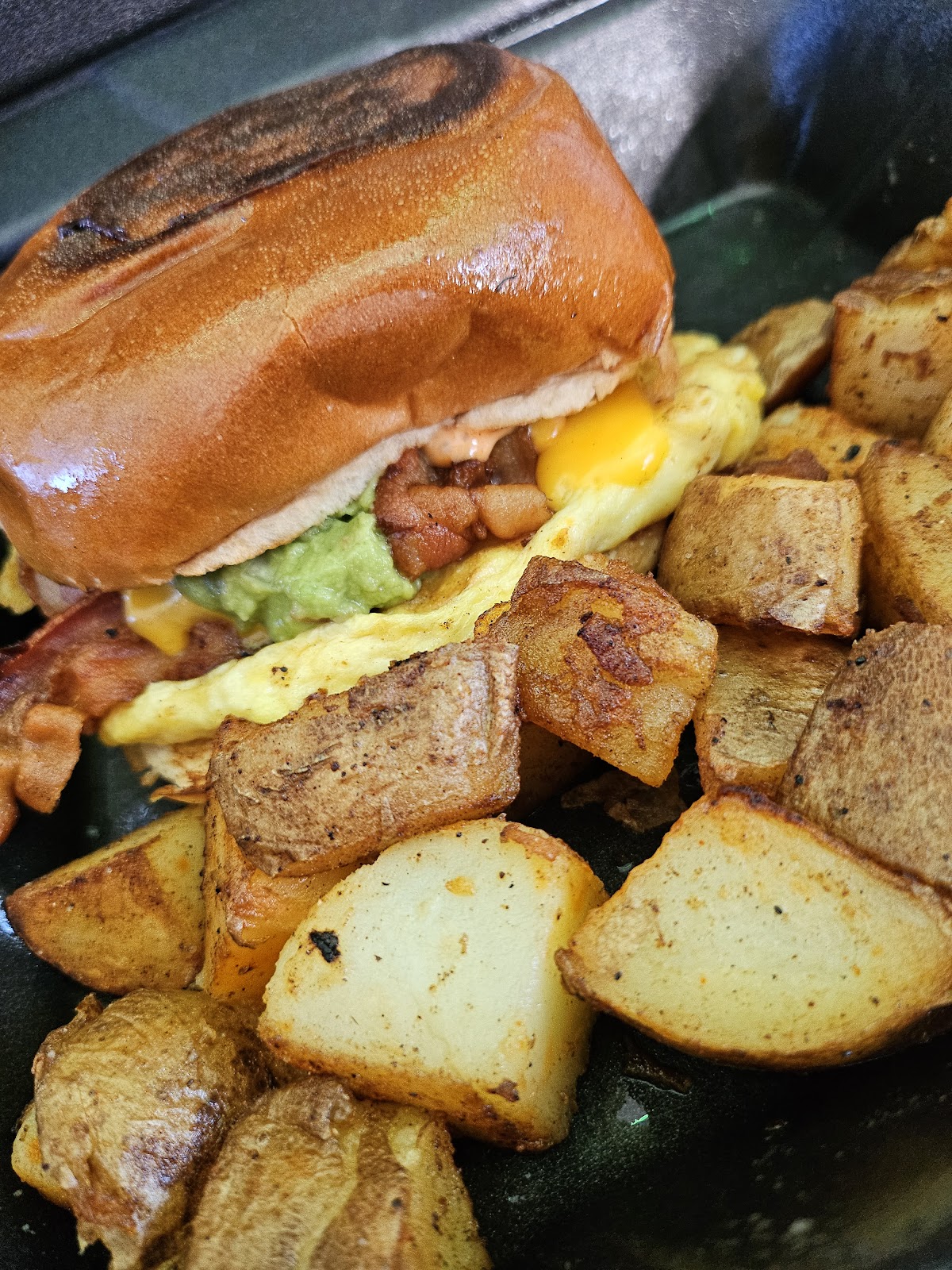 Close-up of a filled sandwich with a side dish photographed at Guadalajara Street Tacos & Hotdogs